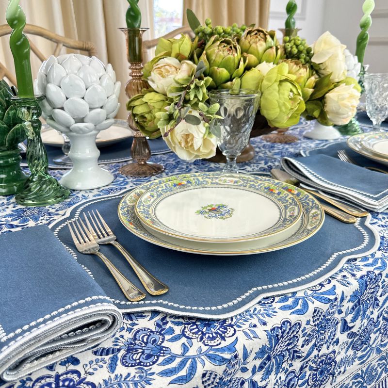 Autumn blue placemat with white embroidery and matching napkin and blue floral tablecloth