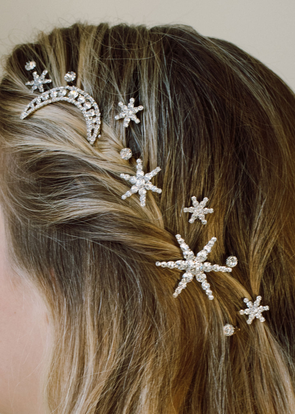 Close-up of Supernova Bobby Pin Set on model’s hair showcasing Swarovski crystal star and moon motifs on gold-plated pins