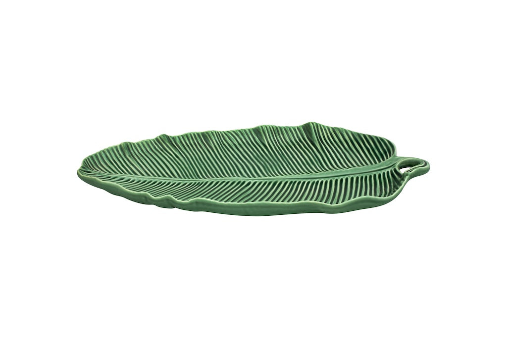 Angled side view of Banana Leaf platter showcasing raised ribbed texture and green glazed earthenware on white background