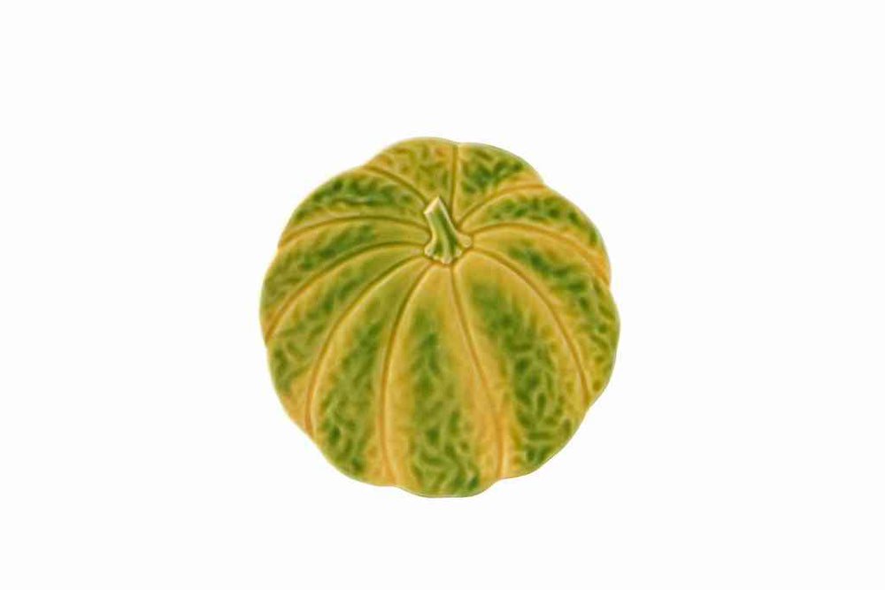 Top view of pumpkin dessert plate with ridged pumpkin shape and green-yellow mottled glaze on white background
