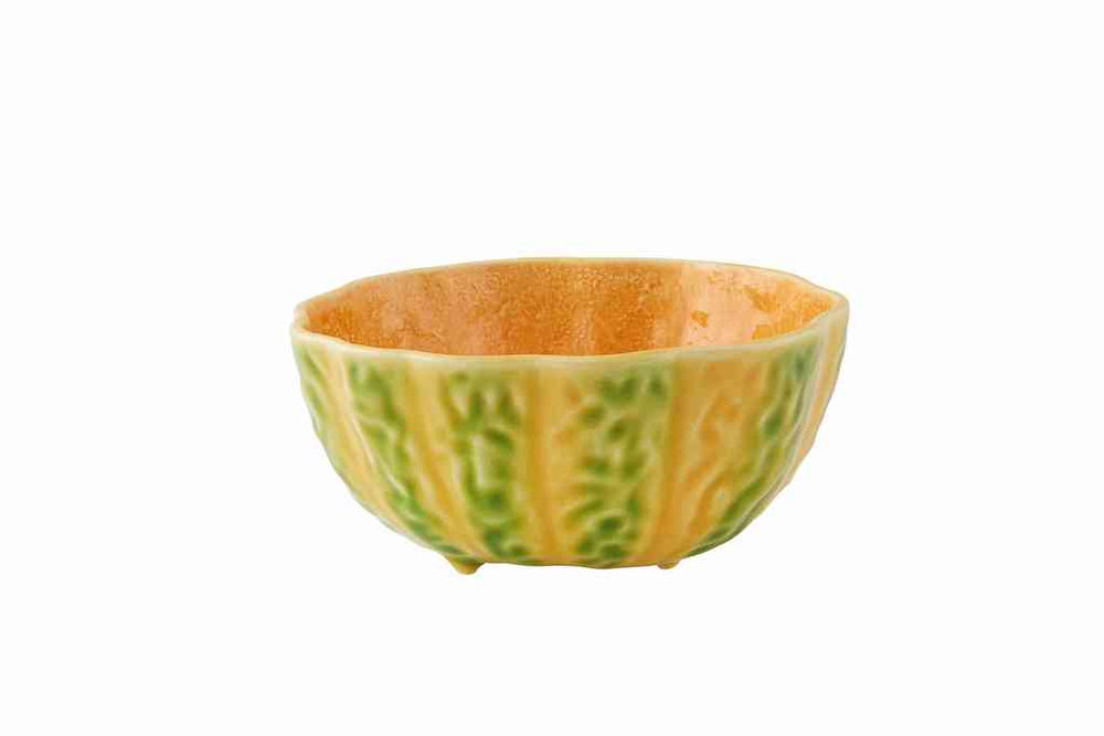 Angled view of small pumpkin bowl with ribbed pumpkin shape, green and orange glaze, and three small feet on white background