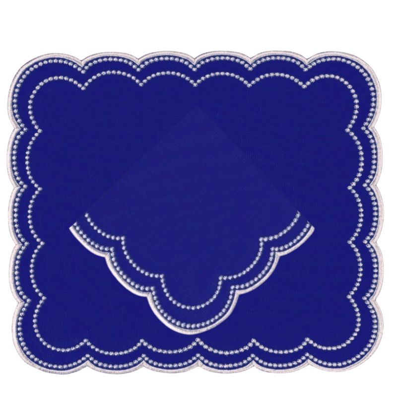 Luxury embroidered royal blue placemat and napkin with two rows of white dotted rows scalloped . 