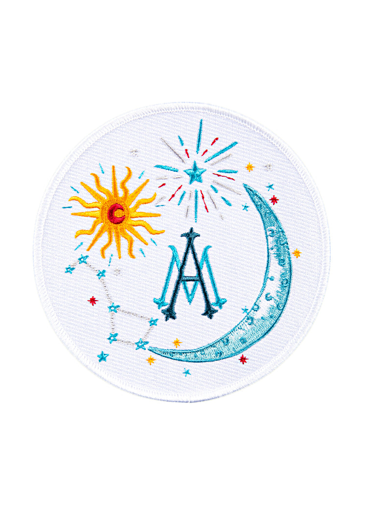 Front view of Celestial Crest patch showcasing embroidered sun, crescent moon, stars, and stylized OTM monogram on white background