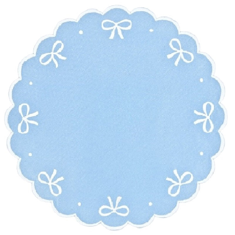 Embroidered blue placemat with white bows