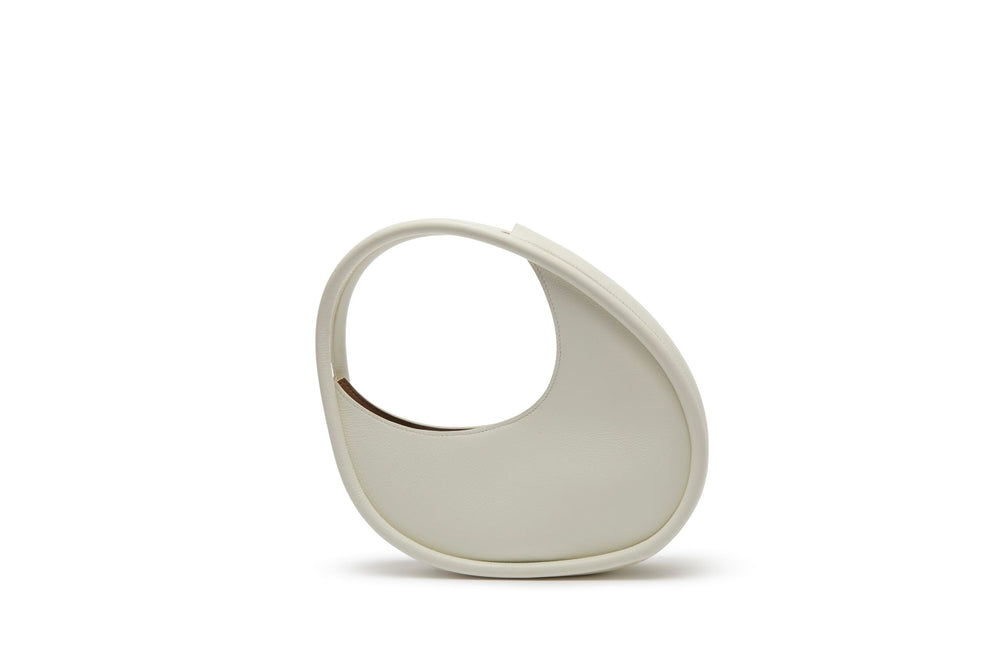 Front view of Ostra Double Piping Micro bag showcasing crescent shape and integrated top handle on white background