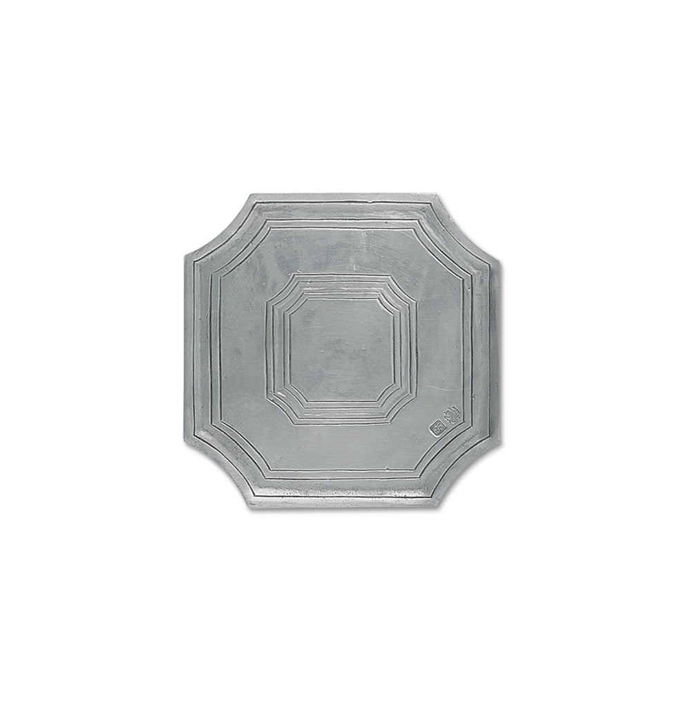 Top-down view of octagonal metal trivet showing stepped concentric borders and pewter finish on white background