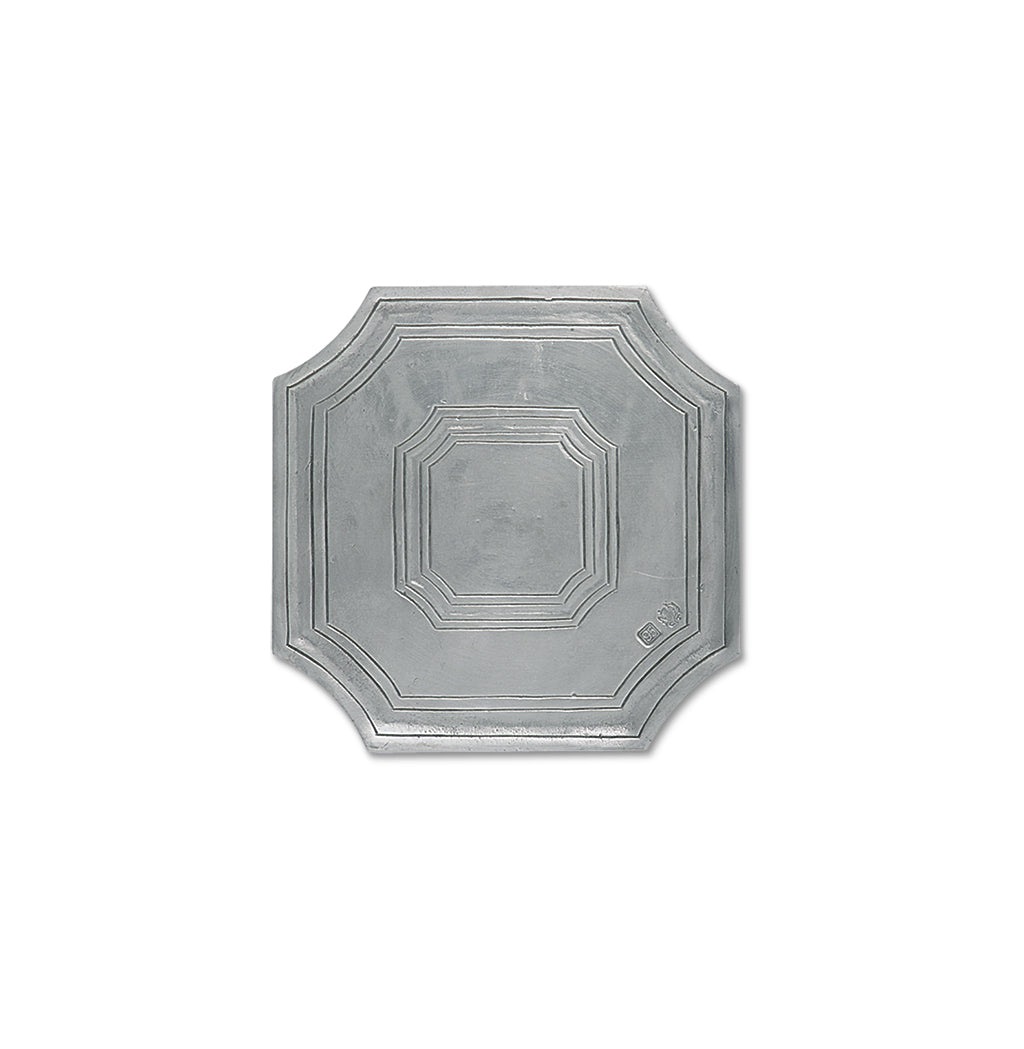 Top-down view of octagonal metal trivet showing stepped concentric borders and pewter finish on white background