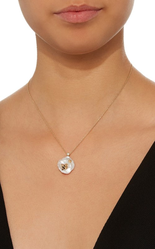 Front view of Bee My Honey Pendant necklace showcasing pearl charm and enamel bee motif on a model in a black top