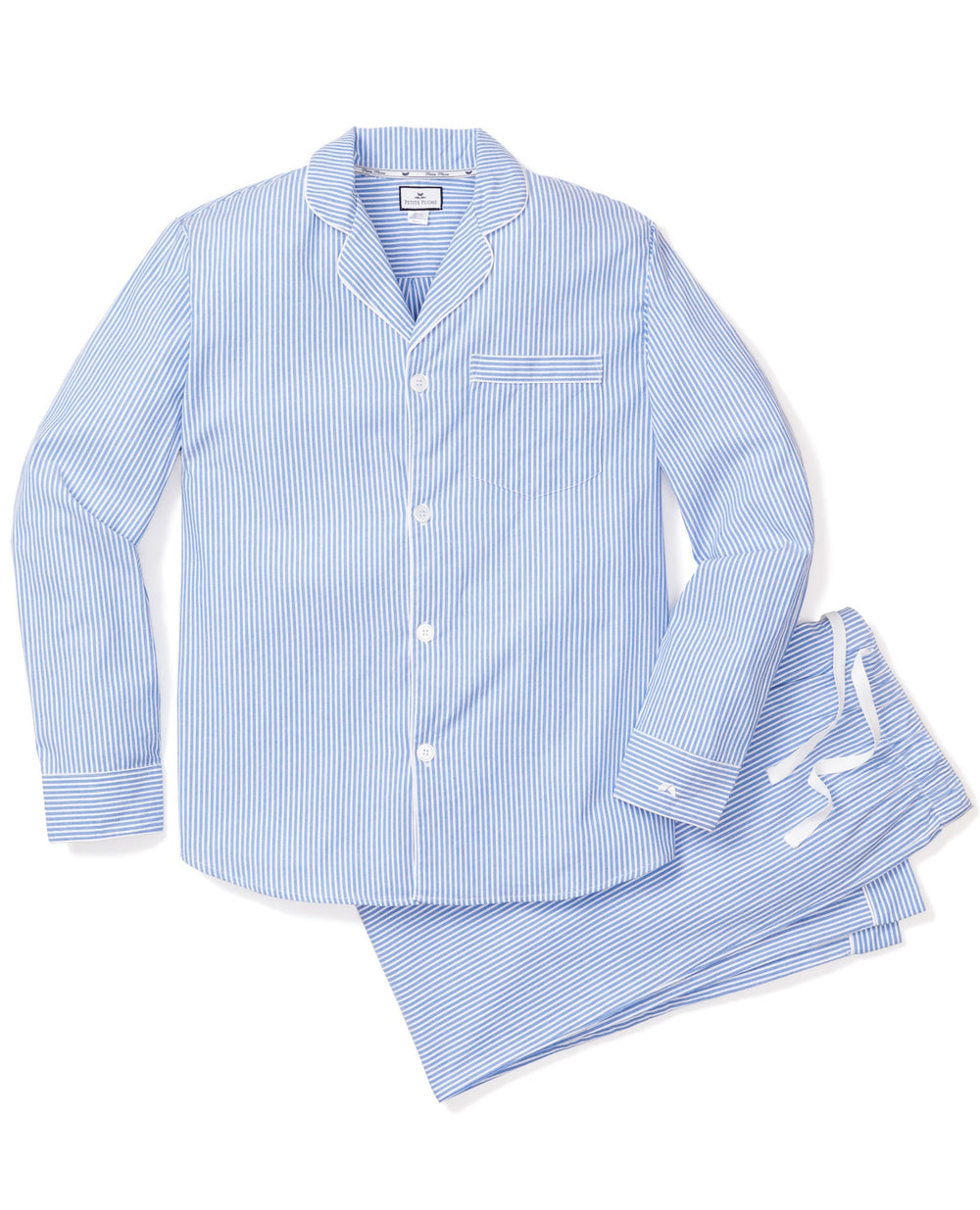Flat lay of men’s French blue seersucker pajama set with striped shirt, contrast piping, and matching pants on white