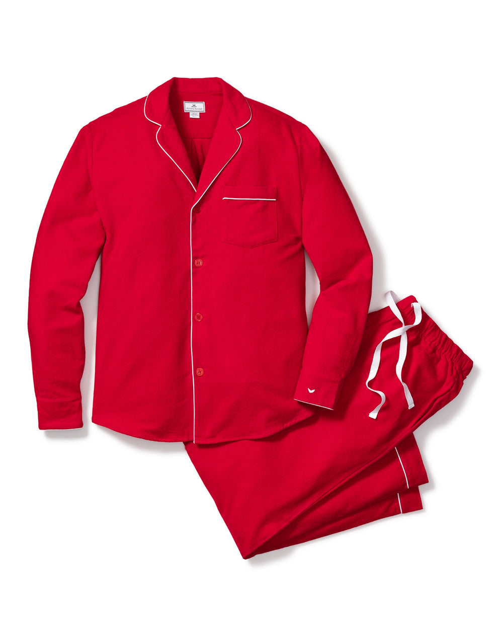 Flat-lay of men’s red flannel pajama set with white contrast piping, button-front top and drawstring pants on white