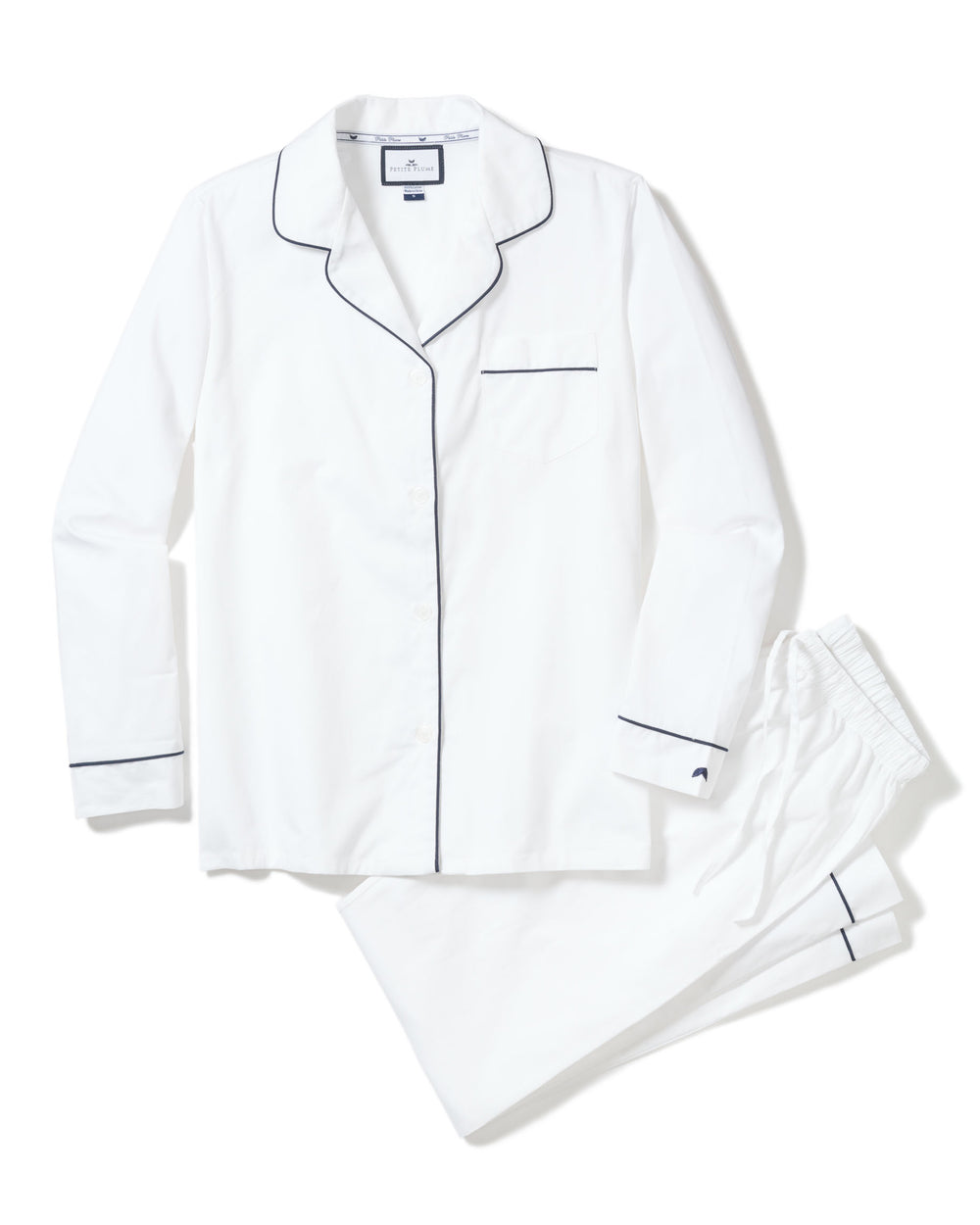 Front view of men’s white pajama set with navy piping showcasing a button-front shirt and pants on a white background