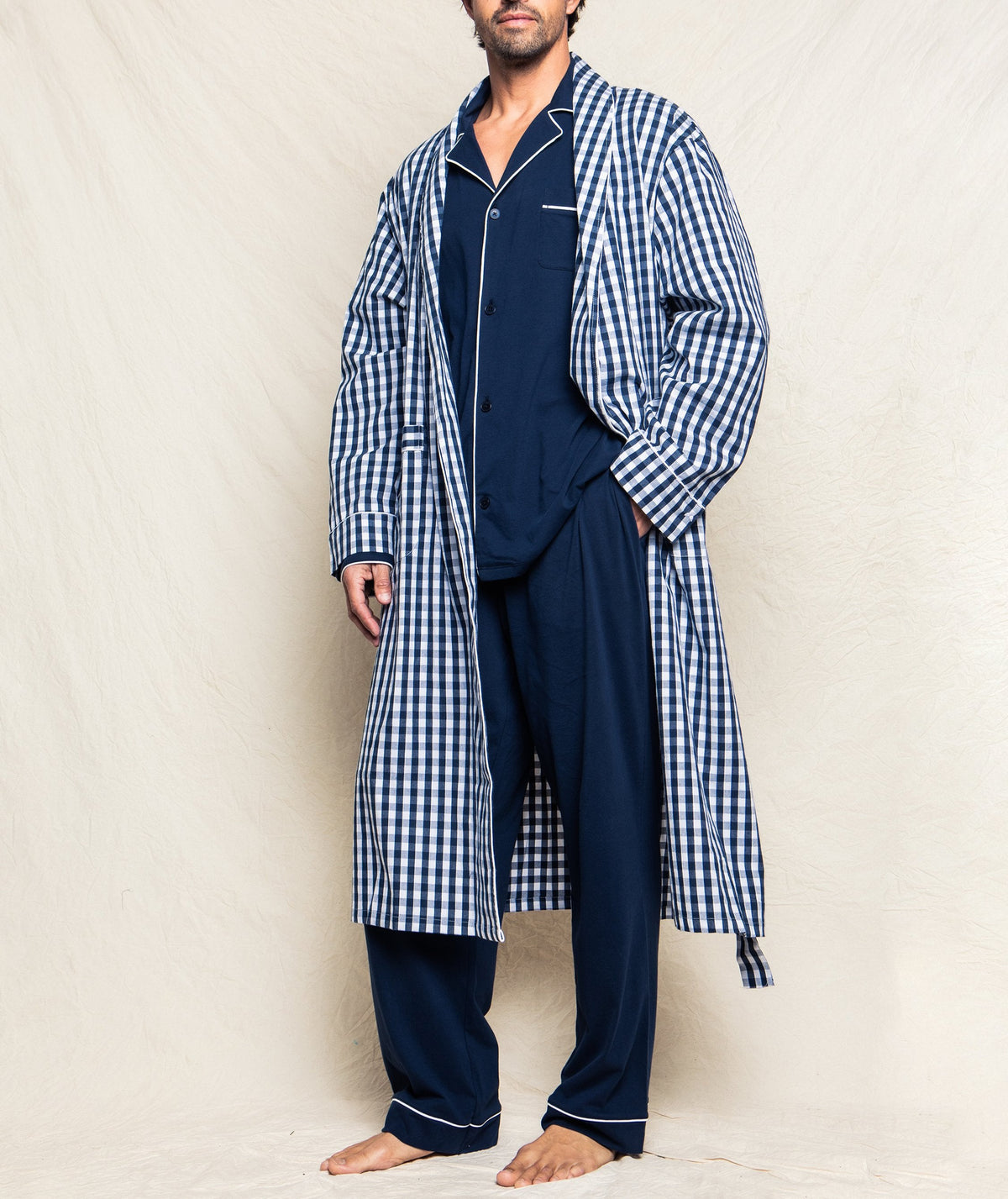 Front view of Men’s Navy Gingham Robe showcasing its checkered pattern, white piping, and belt on a model against a light background