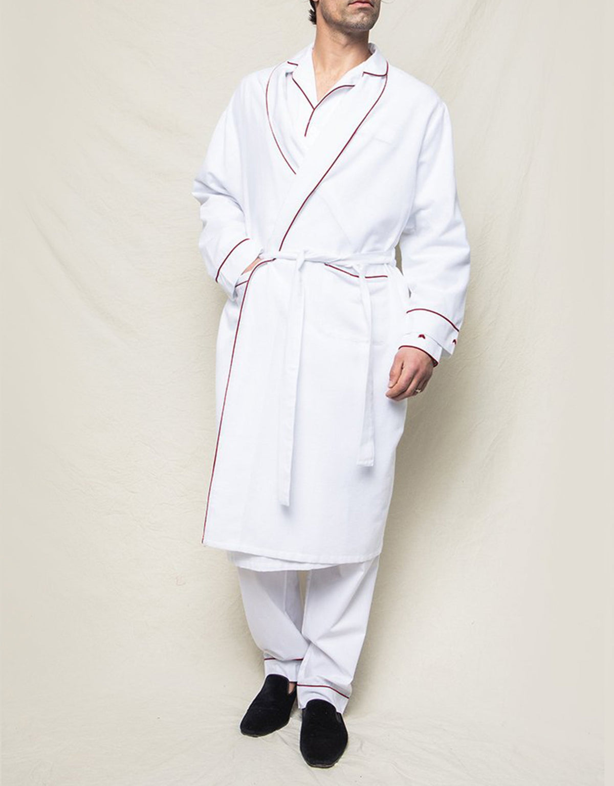 Front view of men’s white flannel robe showcasing red piping and tie belt with a neutral background