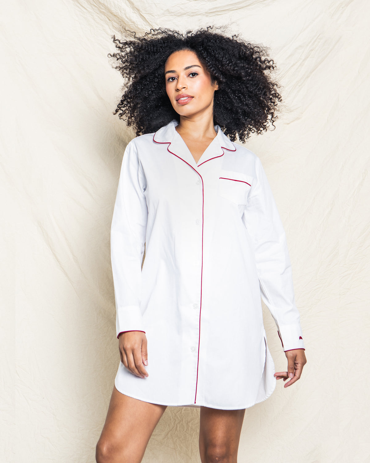 Front view of Women’s White Twill Nightshirt with Red Piping showcasing pearl buttons on a model against a white backdrop