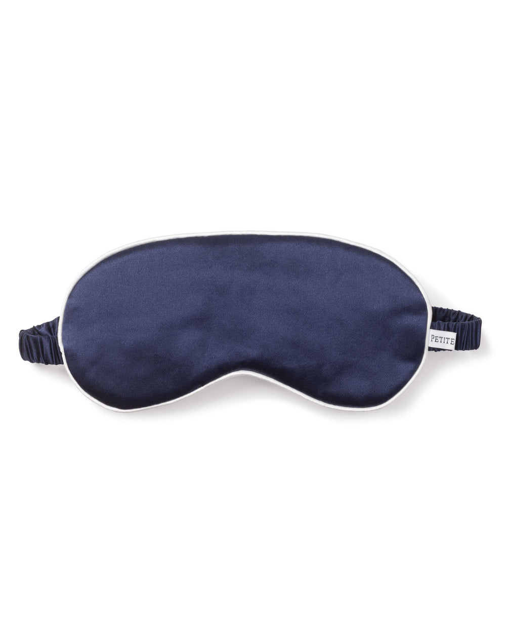 Front view of navy silk eye mask showing white piped edge and ruched elastic strap on white background