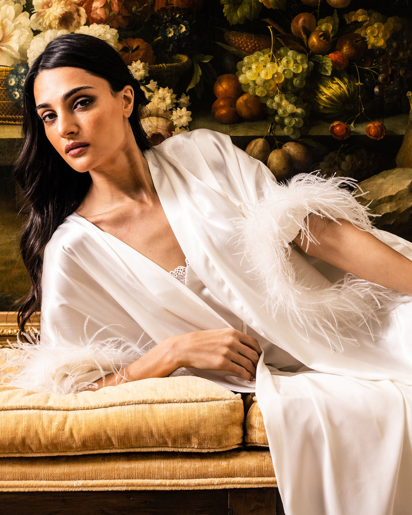 white silk dress with feathers An iconic New Year look White silk dress paired with our signature feather caftan by Maison d'Angelann timeless elegance, pure glamour, and celebration energy in every detail. Available now in