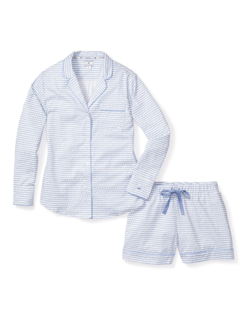 Flat lay of Women’s La Mer long-sleeve pajama set showing light-blue wave print, piped trim, button-front top and drawstring shorts on white background