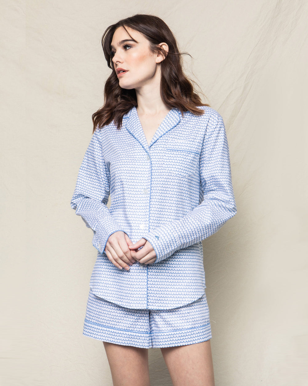 Three-quarter view of La Mer long-sleeve short set showing blue wave print and piped trim
