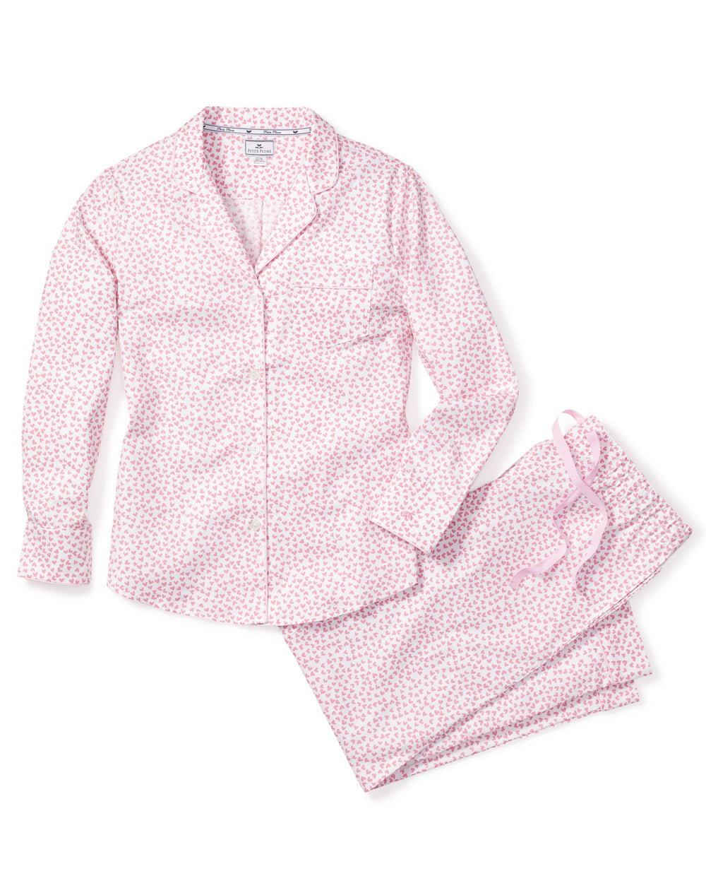 Flat lay of women’s Sweethearts pajama set showing pink heart-print cotton shirt and matching drawstring pants on white background