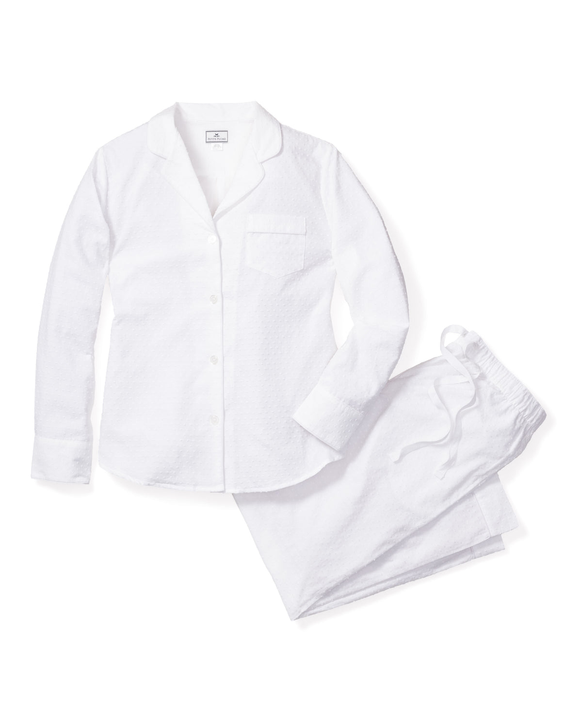Flat lay of Womens Swiss Dots Pajamas showcasing Swiss dot texture, collared button front, and pocket on a white background