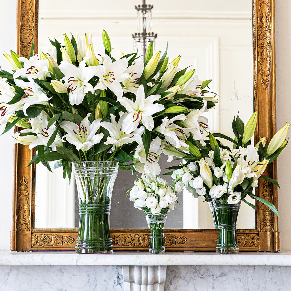 Front view of Ella Corset vase with corseted waist bead detailing filled with white lilies on marble mantel and gold mirror