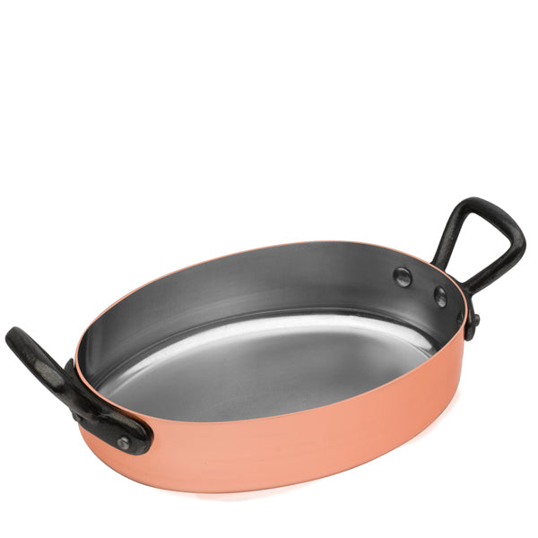 Angled view of Baumalu Oval Serving Dish showcasing copper exterior, tin lining, and riveted cast-iron handles on a white background