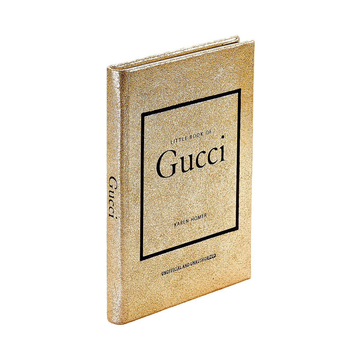 Angled view of Little Book of Gucci in metallic goatskin leather with gold textured cover and black Gucci lettering