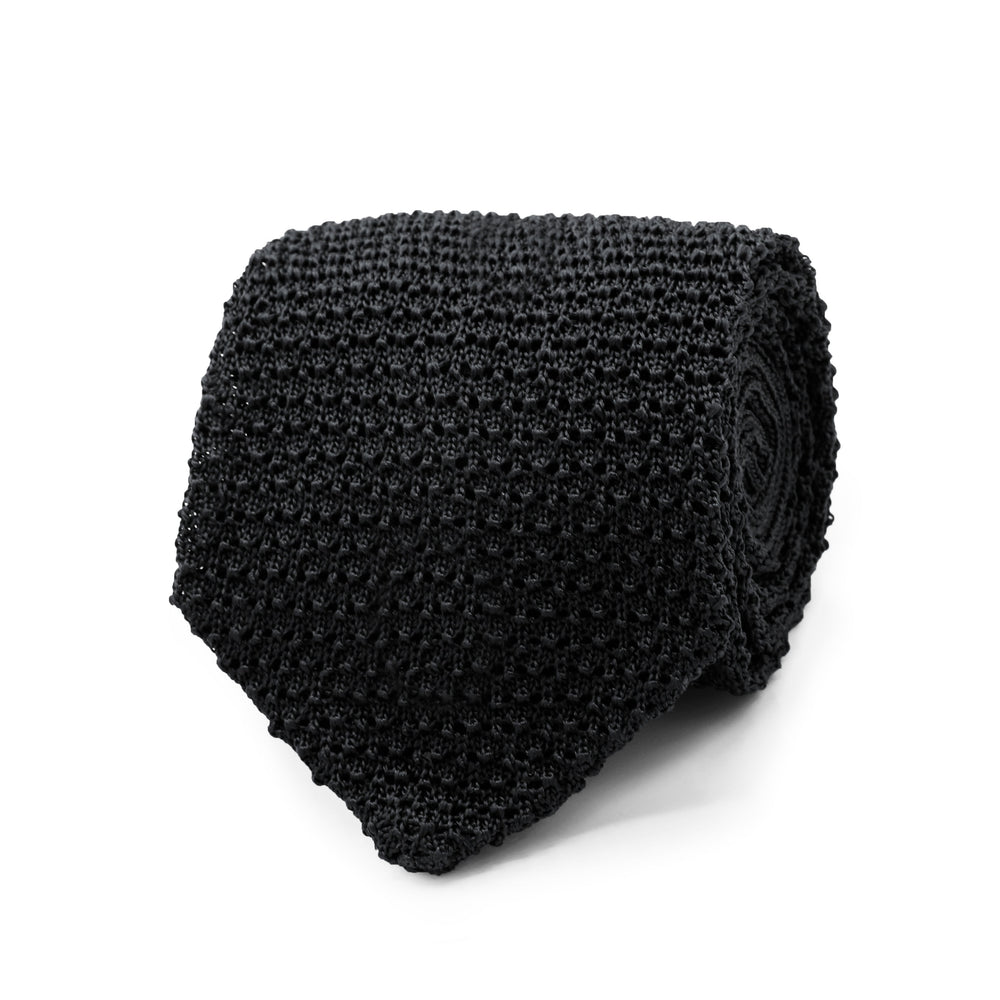 Close-up of Black Knitted Silk Tie showcasing its textured knit, folded on a white background