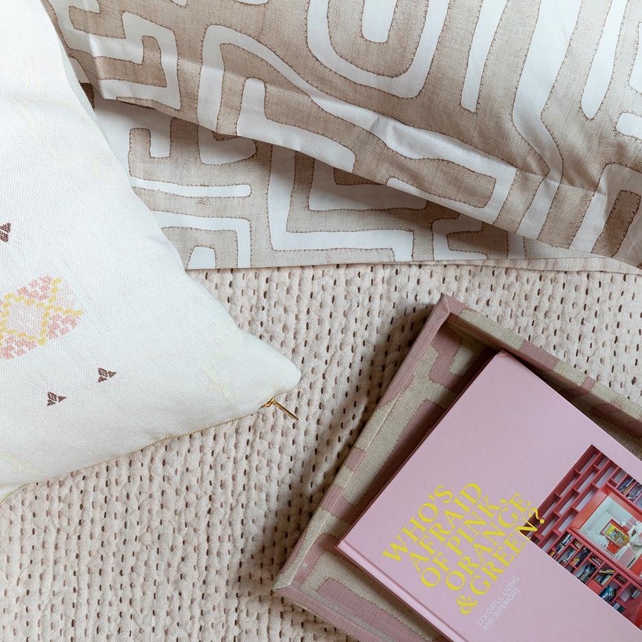 Close-up of Classic Kuba Cloth Duvet in Blush showcasing its geometric pattern on styled bedding