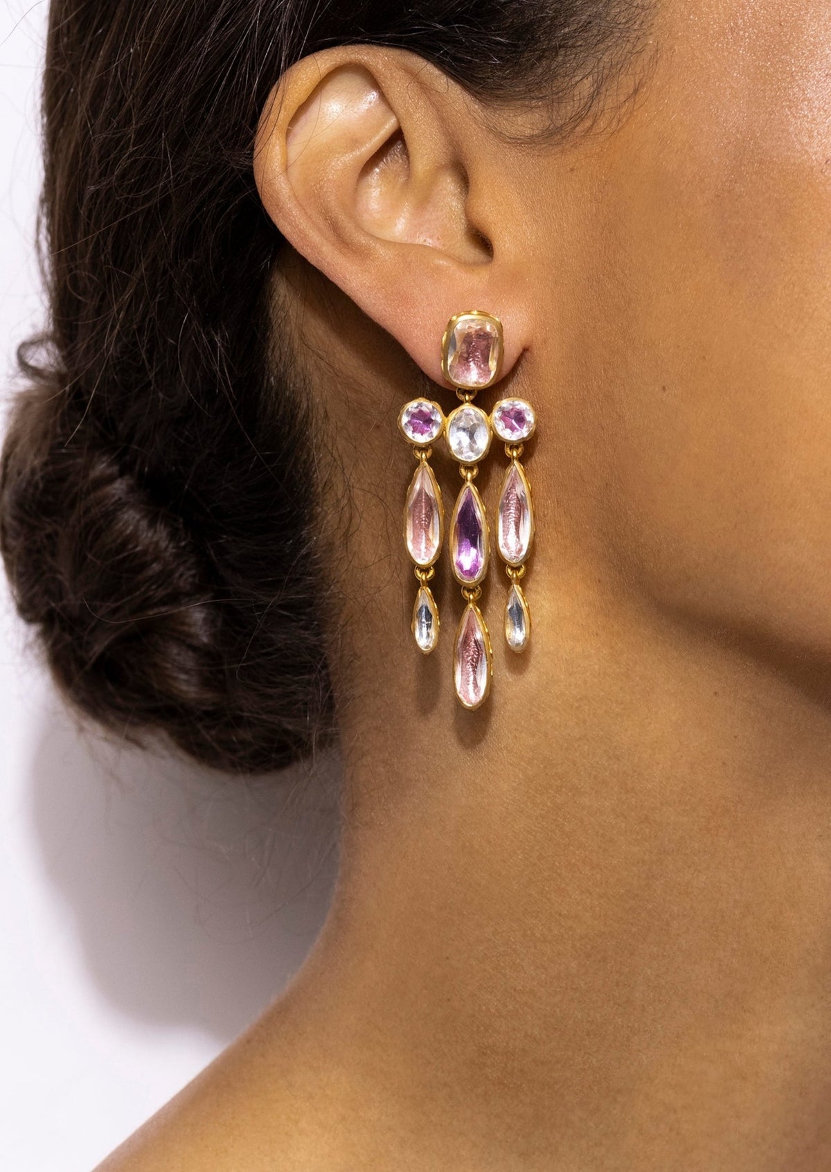 Close-up of Catherine Long Girandole Earrings in Multi-Pink showcasing pink and white pear-shaped stones on an ear