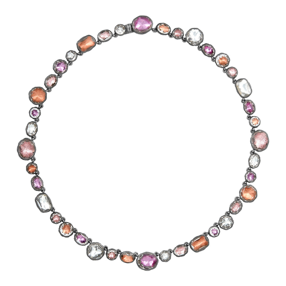 Front view of Catherine Rivière necklace with multi-garden rose foiled white quartz in black rhodium setting on white