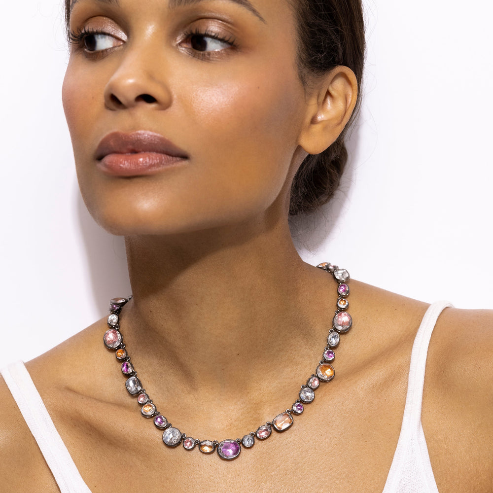 Front close-up of Catherine Rivière necklace, black rhodium with multicolored foiled quartz on model against white background