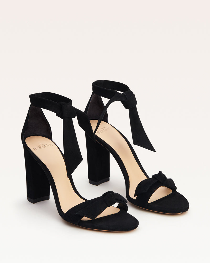 Three-quarter view of Clarita Block 90 in Black Suede showcasing double bows on a light background