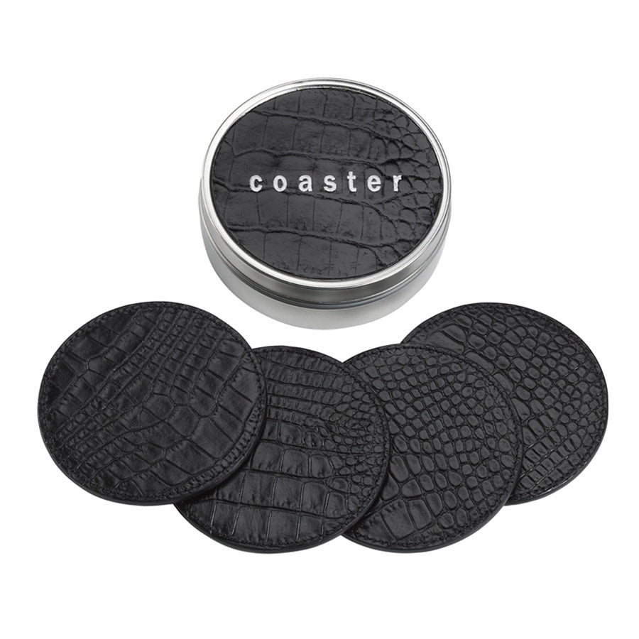 Top view of four black crocodile embossed leather coasters and a silver tin box labeled coaster on white background