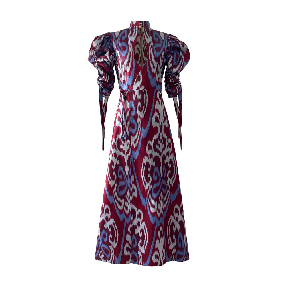 Back view of Wine Candela Dress showcasing Uzbek hand-loom ikat print and gathered puff sleeves with white background