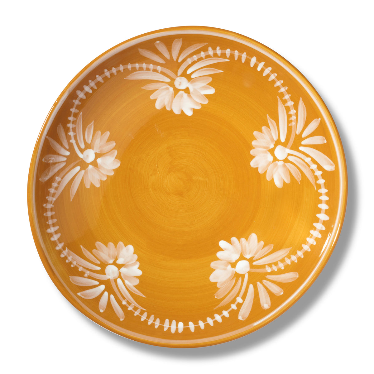Close-up view of Serving Bowl With White Floral Trim in Marigold showcasing its white floral pattern on a white background