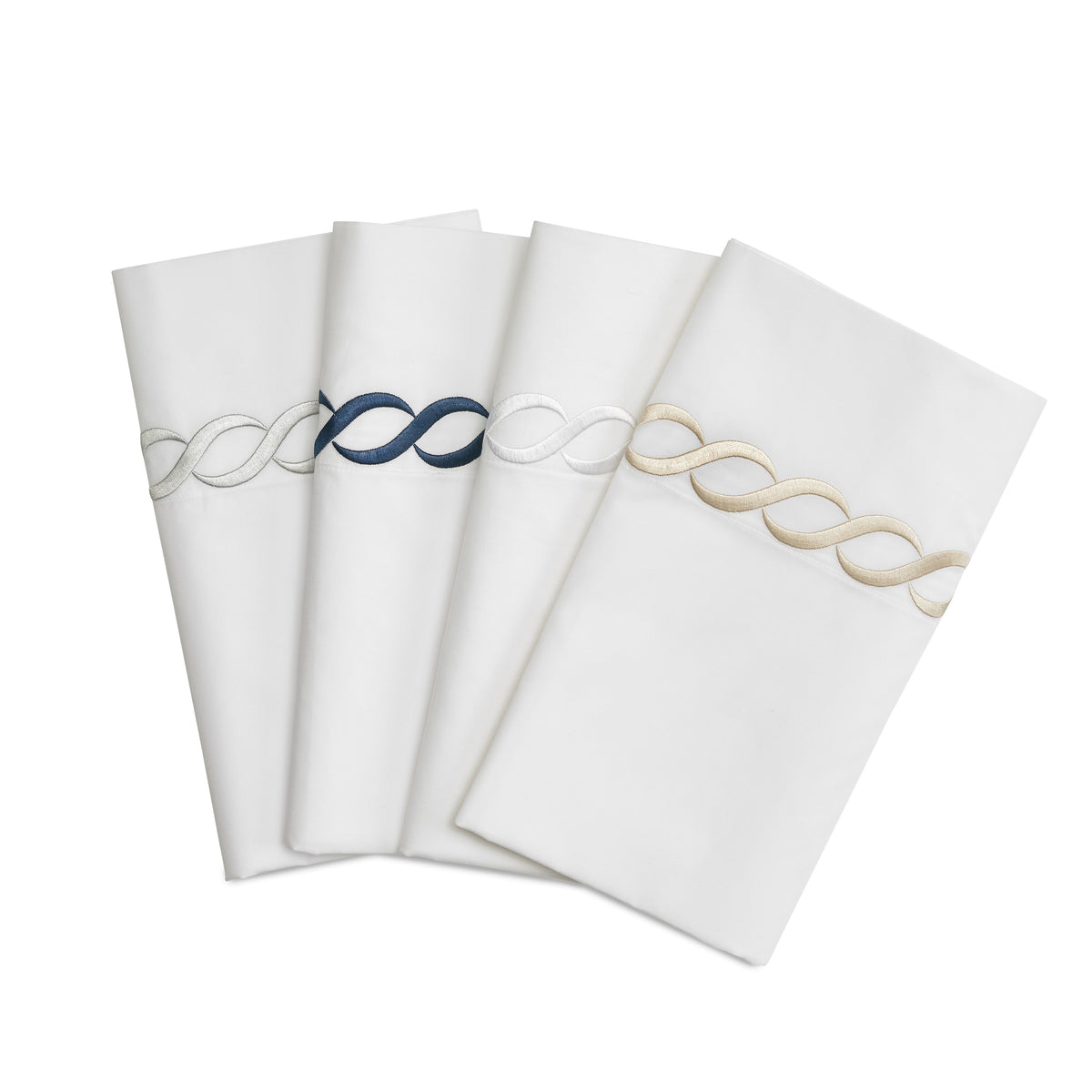Folded Catena King flat sheets showcasing embroidered cable border in navy, silver, white, and taupe on white background