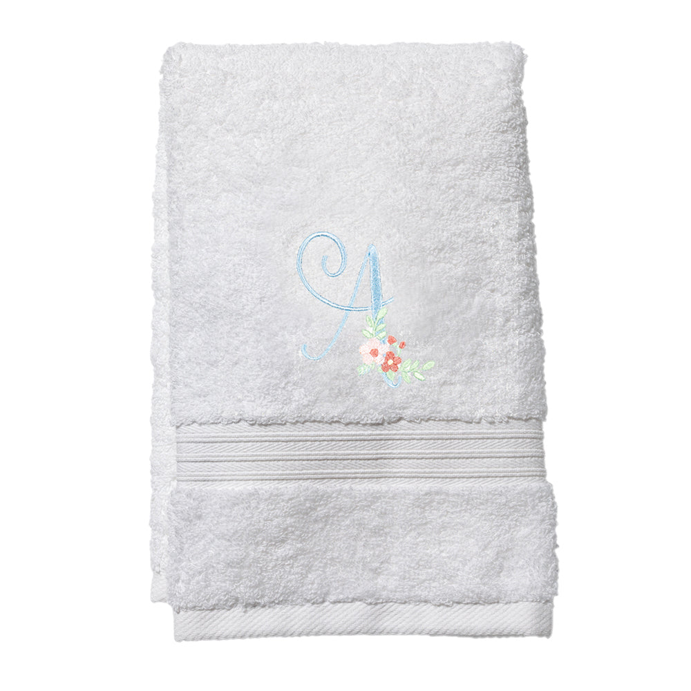 Folded white terry guest towel showing blue embroidered letter A with small pink floral motif on white background