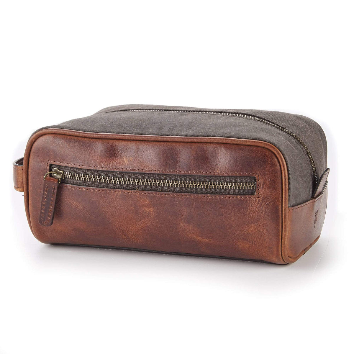 Front three-quarter view of Canvas Dopp Kit with brown leather trim, front zip pocket, gray waxed canvas on white background