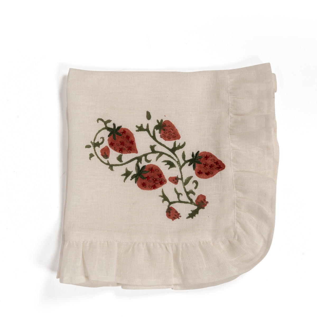 Top view of folded Fraises des Bois linen napkin showcasing hand-blocked strawberry print and ruffled edge on white background