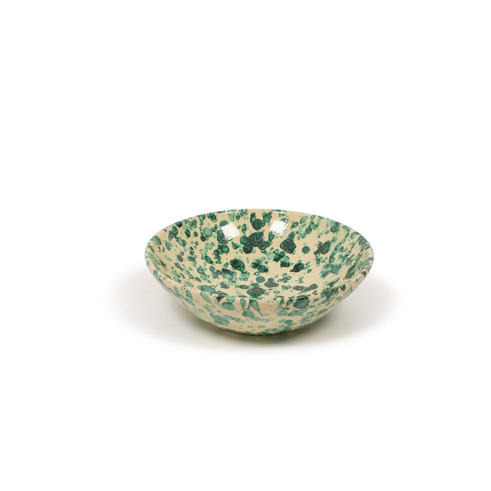 Three-quarter view of Splatter Bowl, Large showcasing green splatter pattern on cream ceramic with white background