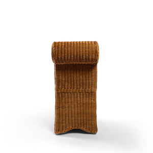 Back side Photo of Sharland-England's Letty slipper chair, hand-crafted from 100% natural rattan and featuring undulating lines and feminine silhouette