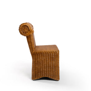 Side Photo of Sharland-England's Letty slipper chair, hand-crafted from 100% natural rattan and featuring undulating lines and feminine silhouette