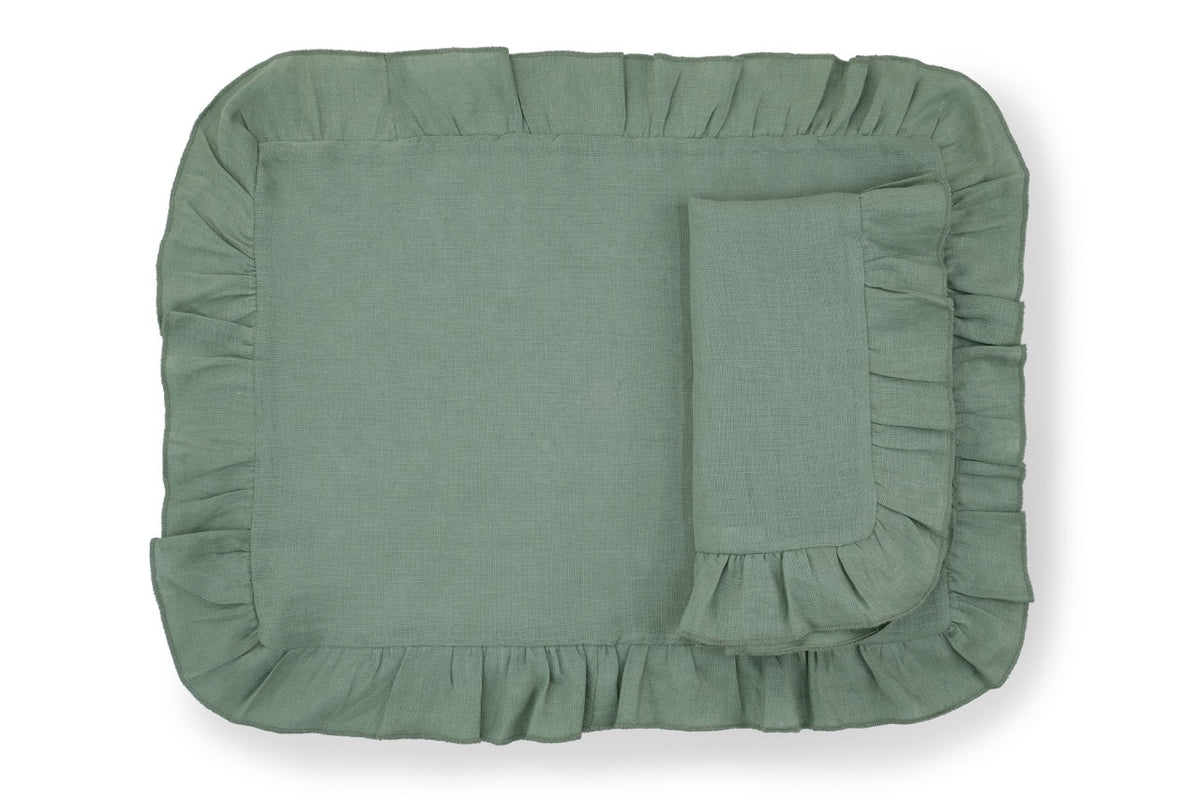 Top-down view of Ruffles Sea Sonen napkin and placemat set showing ruffled edges and linen texture on white background