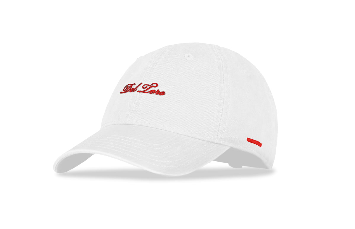 Close-up front view of white embroidered cotton-twill adjustable baseball cap showcasing red Del Toro script logo and side stripe on white background