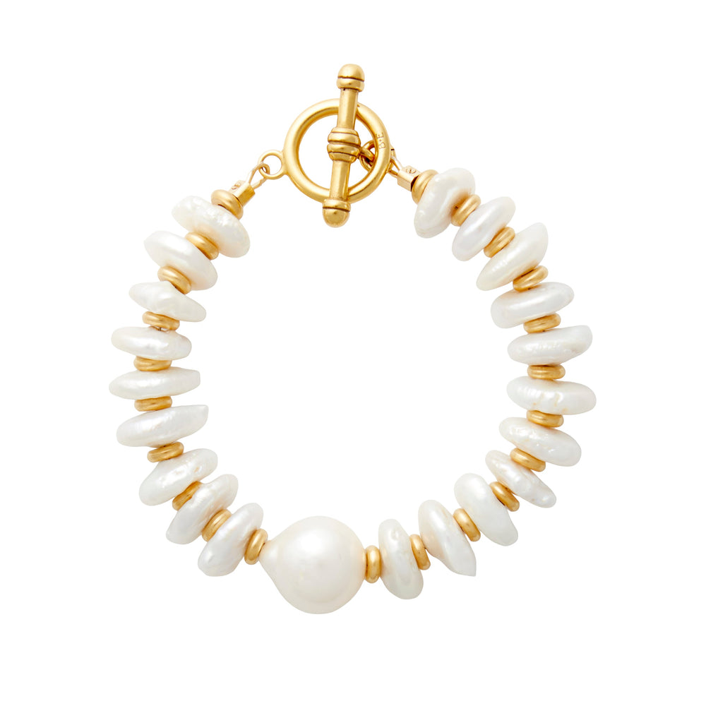 Top-down view of Dune Bracelet showing freshwater pearl discs, larger focal pearl and gold-plated slices on white background