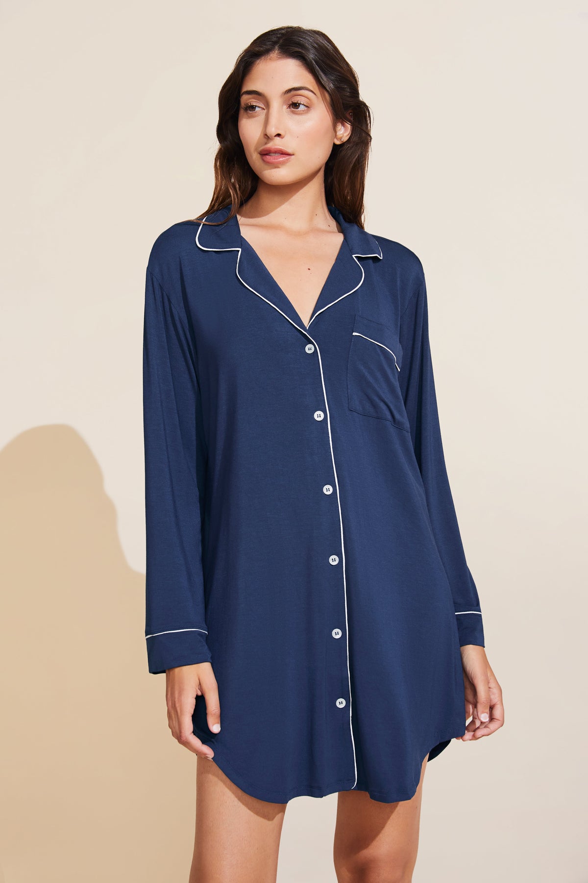 Front view of navy and ivory Gisele Sleepshirt with button front and contrast piping on model against beige background