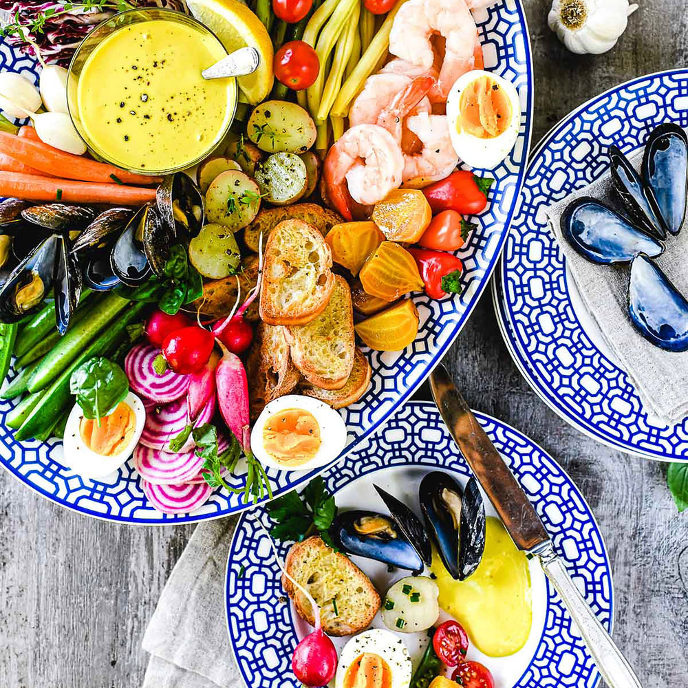 Newport Garden Gate blue and white premium porcelain salad plates and large oval platter from Caskata.