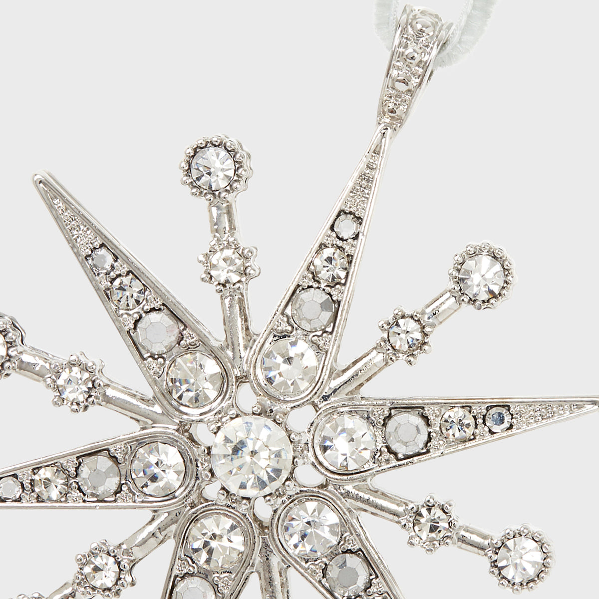 Close-up view of Deco Snowflake Hanging Ornament in Crystal showcasing silver metalwork and faceted crystal stones with a light gray background