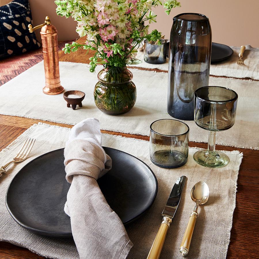 Styled view of Fog Linen Napkin showcasing hand-dyed linen with a subtle gradient and fringed edges in a table setting